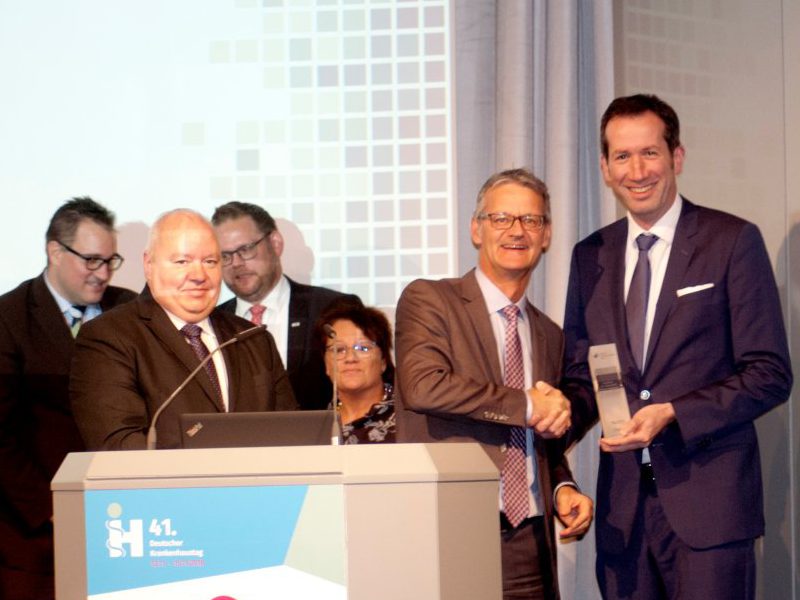 Dr. Gaß, Präsident der Deutschen Krankenhausgesellschaft, überreicht auf dem Deutschen Krankenhaustag den Award Patientendialog an Mark Raschke, Leiter Unternehmenskommunikation des Klinikums Dortmund.